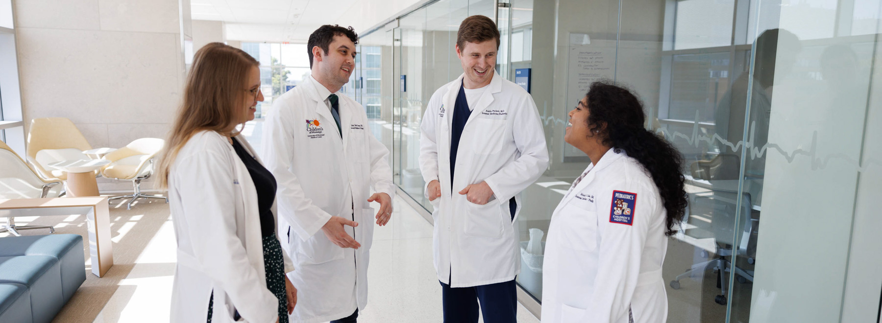 four residents conversing in a corridor